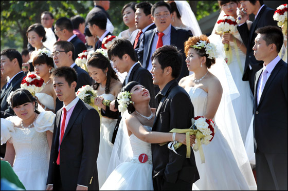  صورة رقم 1 - بالصور.. 21 زوجا صينيا يعقدون قرانهم في حفل زفاف جماعي!! 